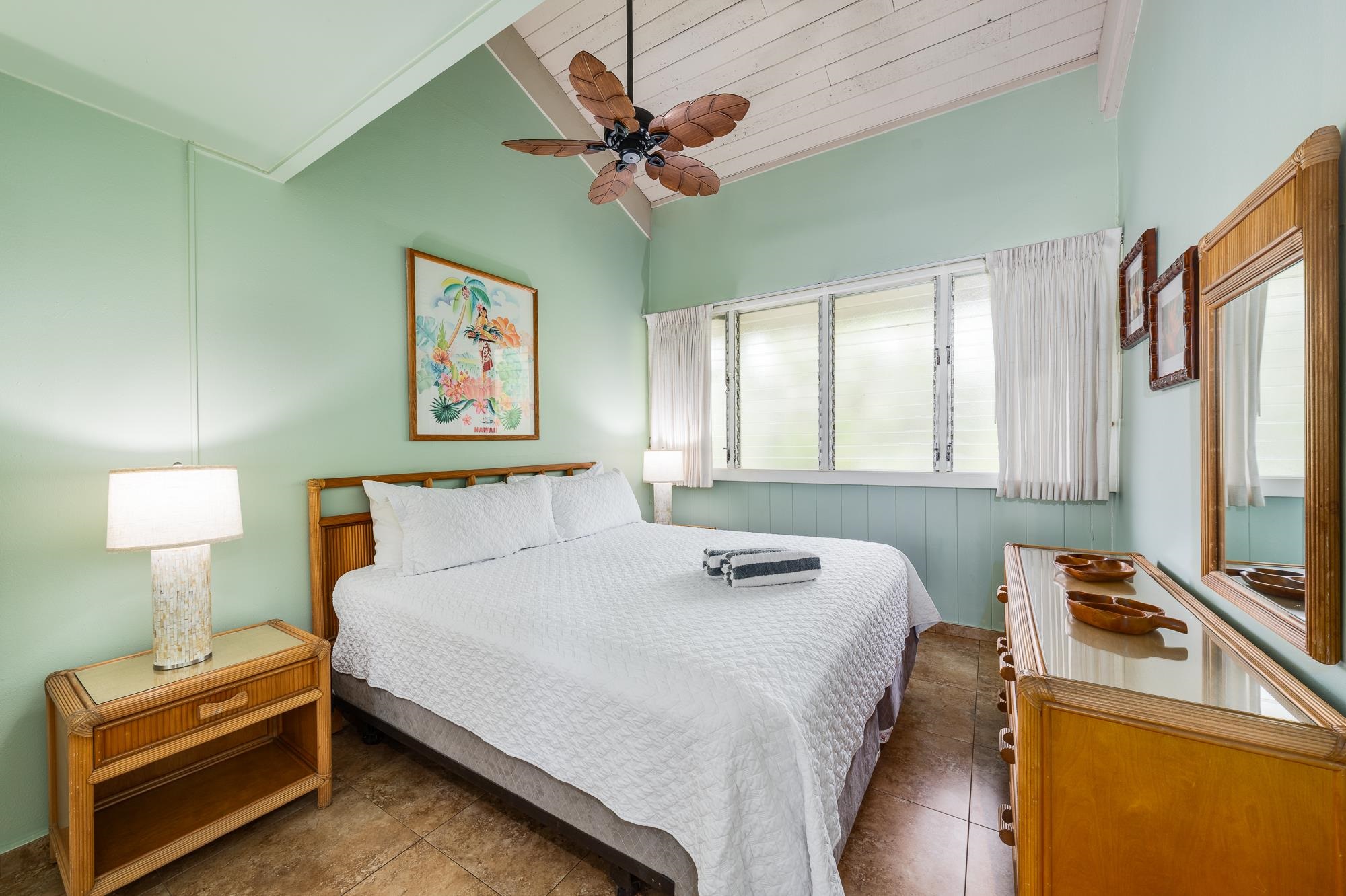 5255 Lower Honoapiilani Road, Unit 207 Lahaina, HI 96761 - Photo 16 of 49 a bedroom with a bed and a chandelier