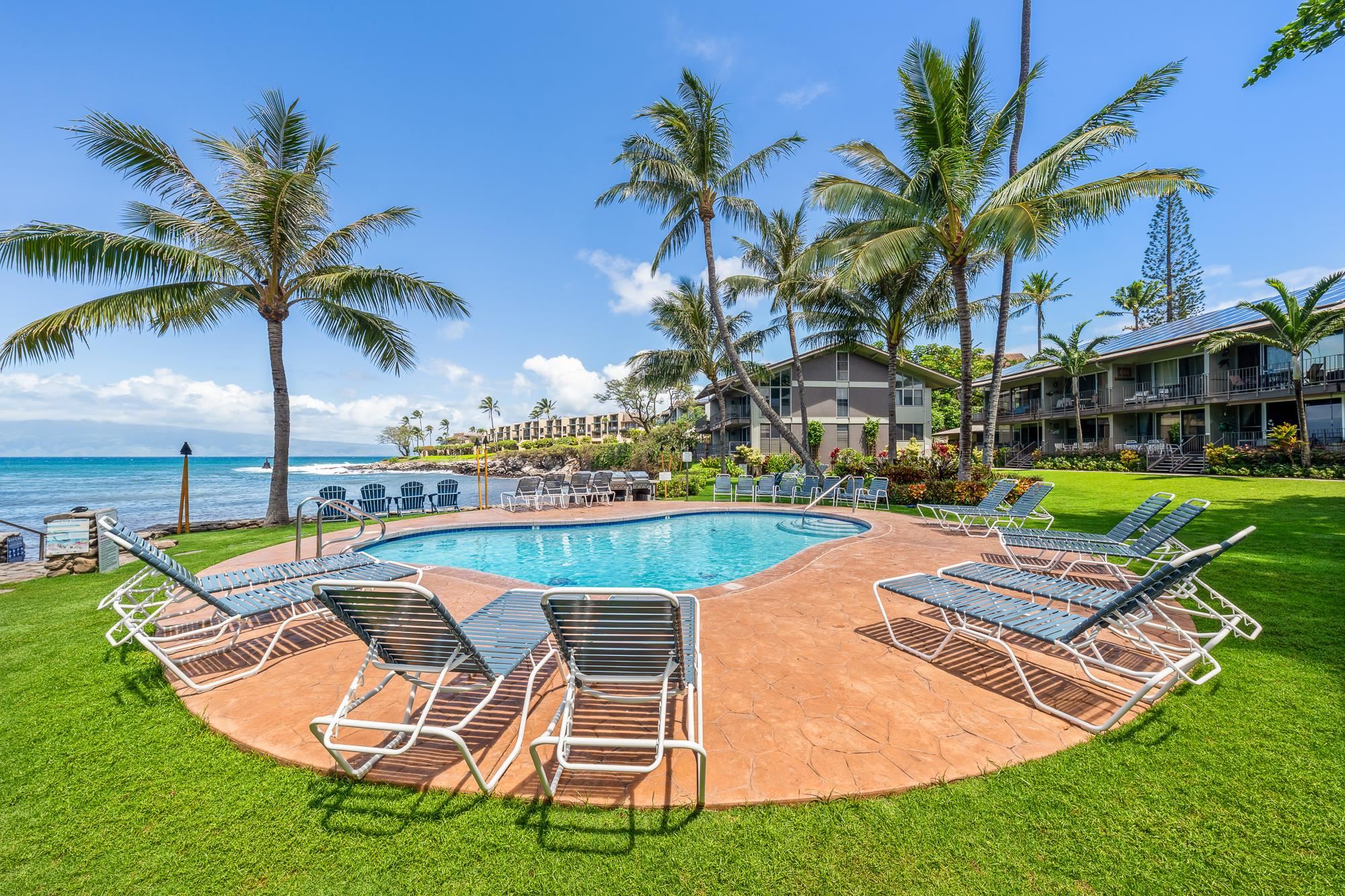 5255 Lower Honoapiilani Road, Unit 207 Lahaina, HI 96761 - Photo 18 of 49 a view of a swimming pool with lounge chairs