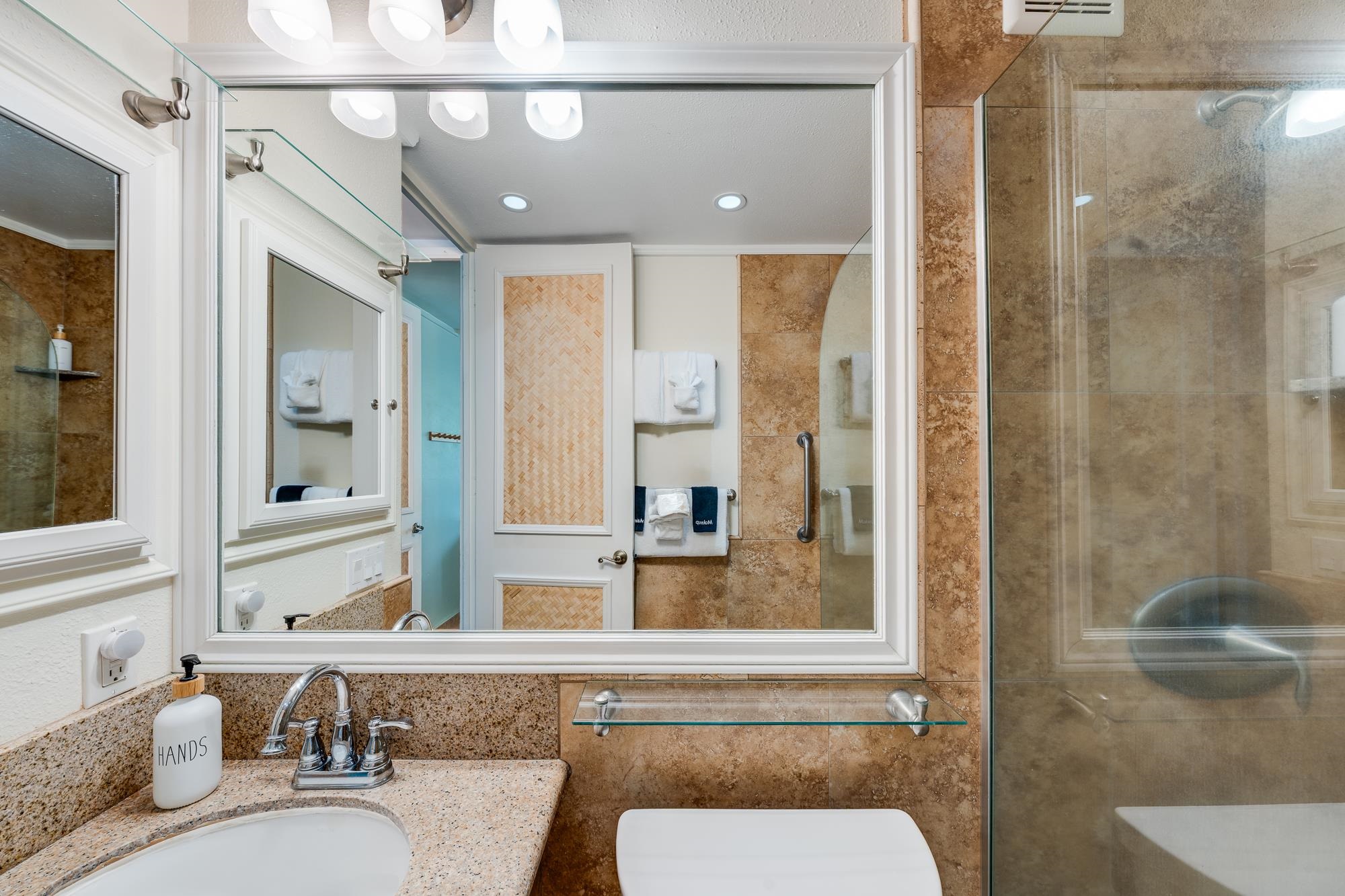 5255 Lower Honoapiilani Road, Unit 207 Lahaina, HI 96761 - Photo 24 of 49 a bathroom with a granite countertop sink and a mirror
