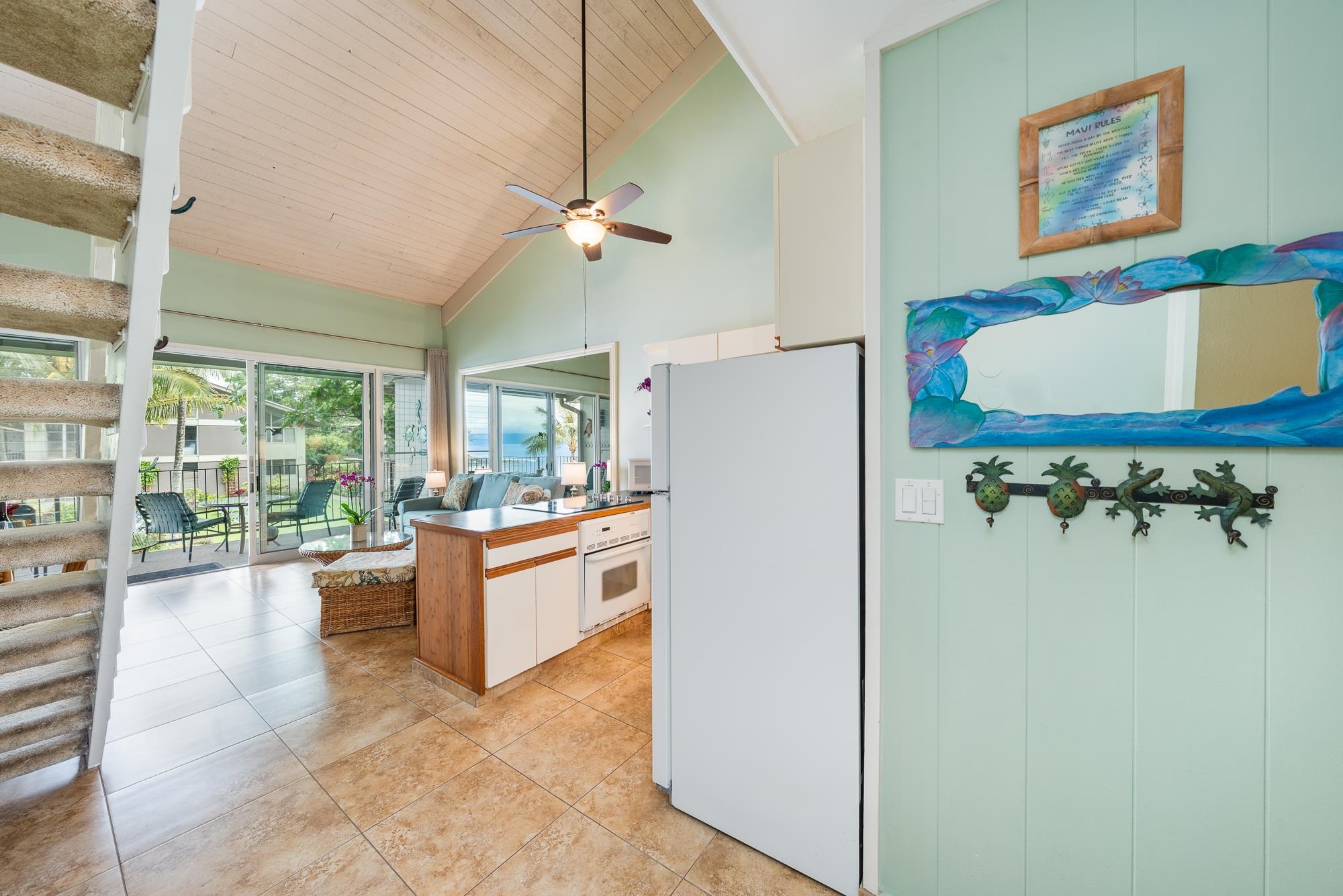 5255 Lower Honoapiilani Road, Unit 207 Lahaina, HI 96761 - Photo 25 of 49 a large living room with stainless steel appliances granite countertop furniture a fireplace and a large window