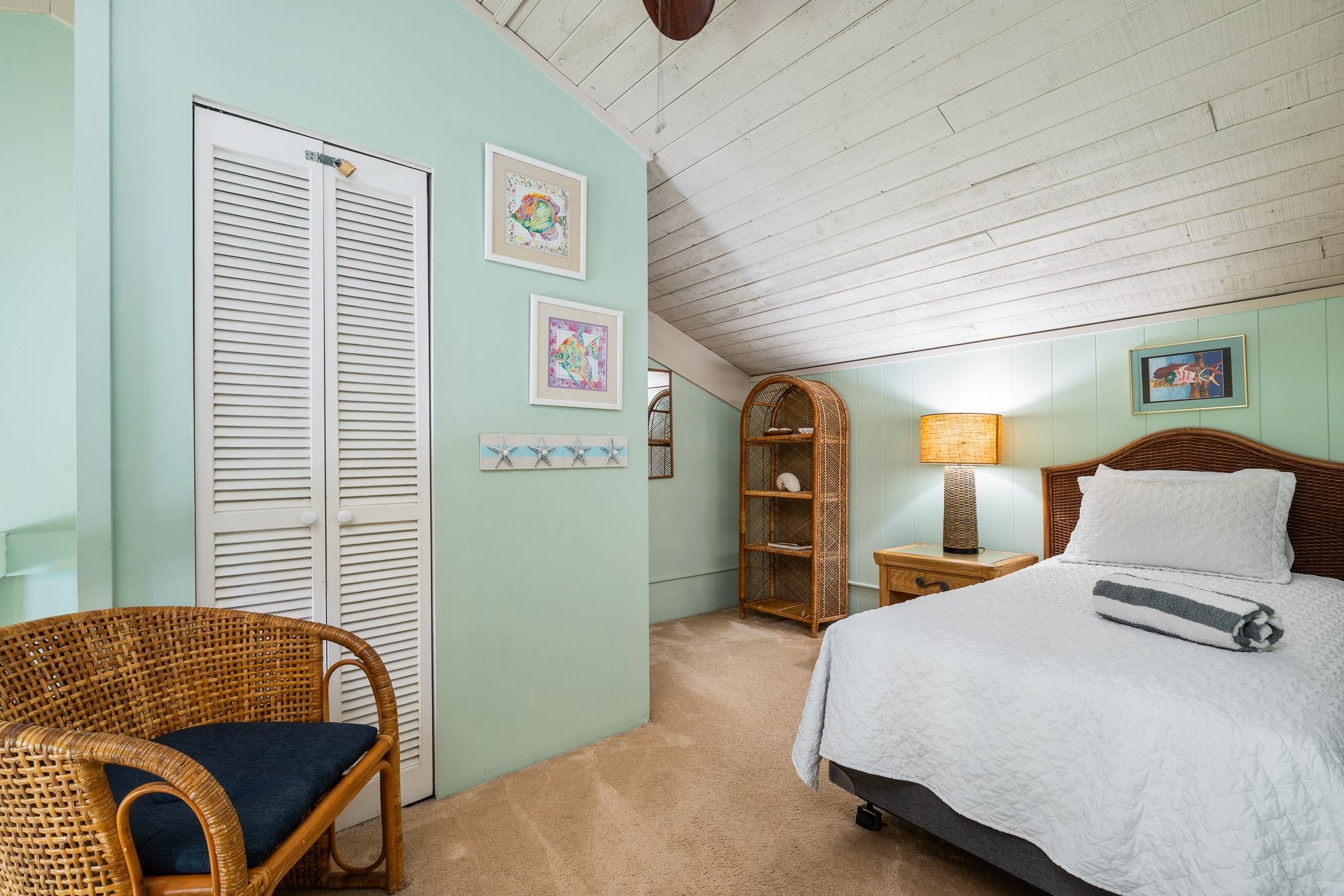 5255 Lower Honoapiilani Road, Unit 207 Lahaina, HI 96761 - Photo 28 of 49 a bedroom with a large bed and a window