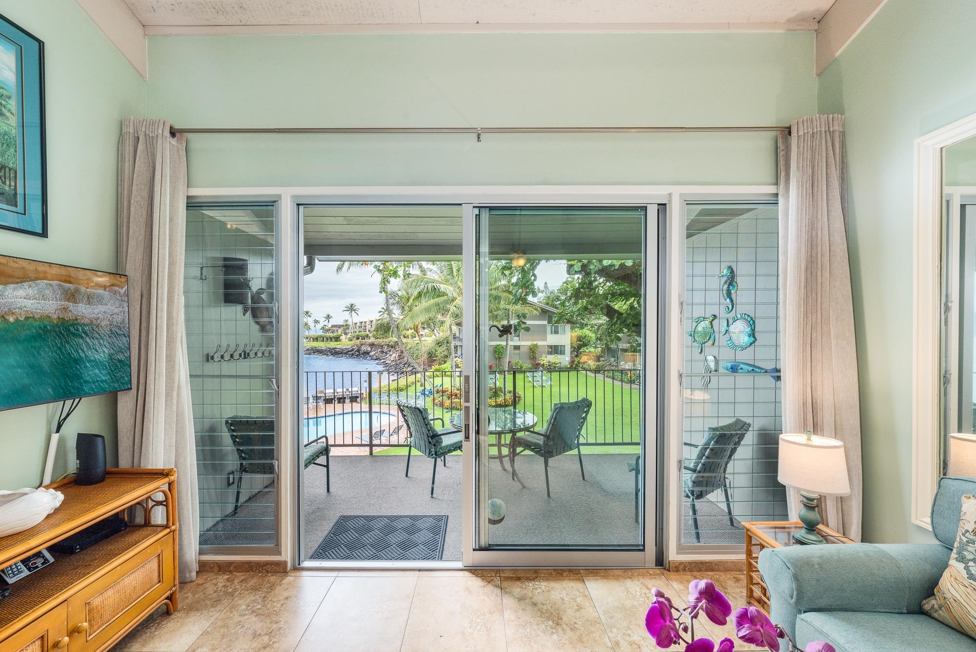 5255 Lower Honoapiilani Road, Unit 207 Lahaina, HI 96761 - Photo 31 of 49 a living room with furniture and a floor to ceiling window