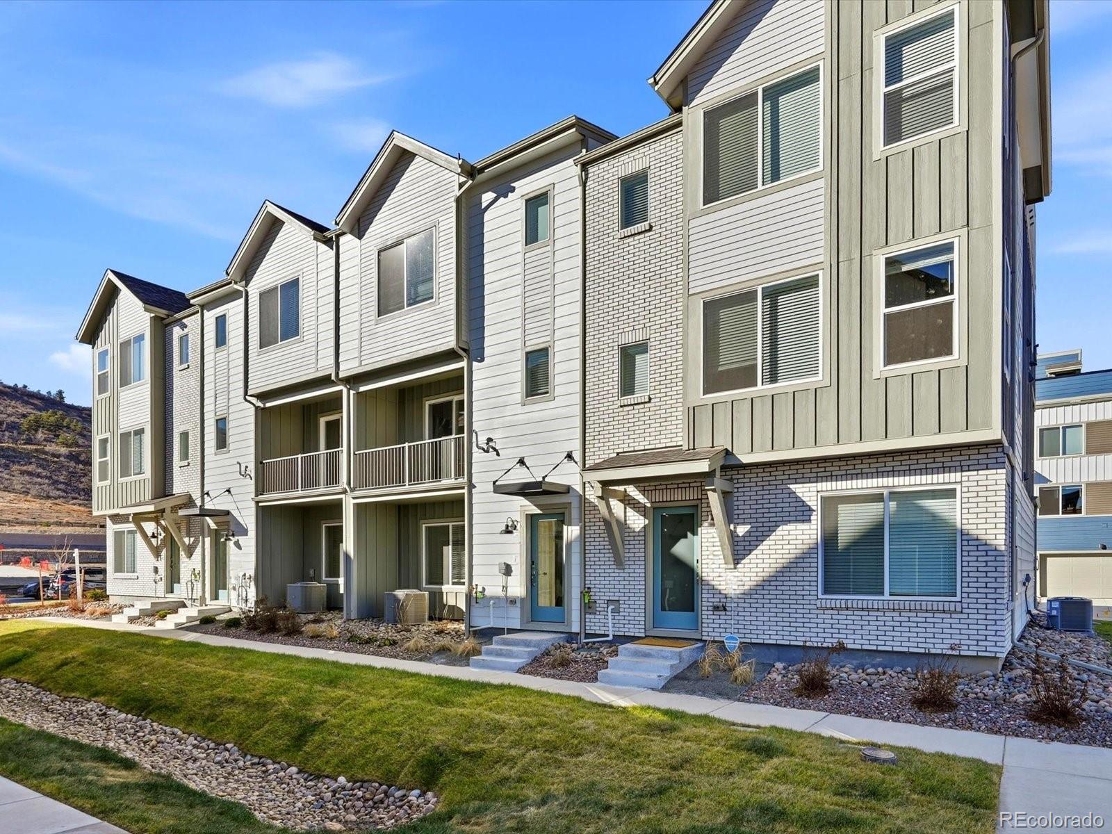a front view of a residential apartment building with a yard