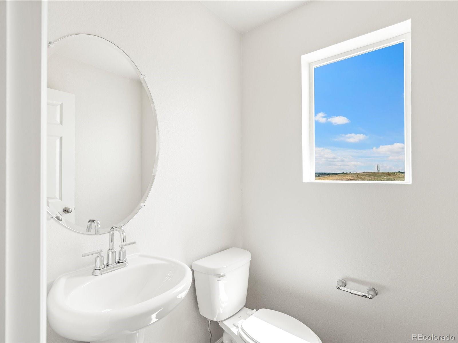 14472 Pansy Loop Morrison, CO 80465 - Photo 17 of 37 a bathroom with a toilet a sink and mirror