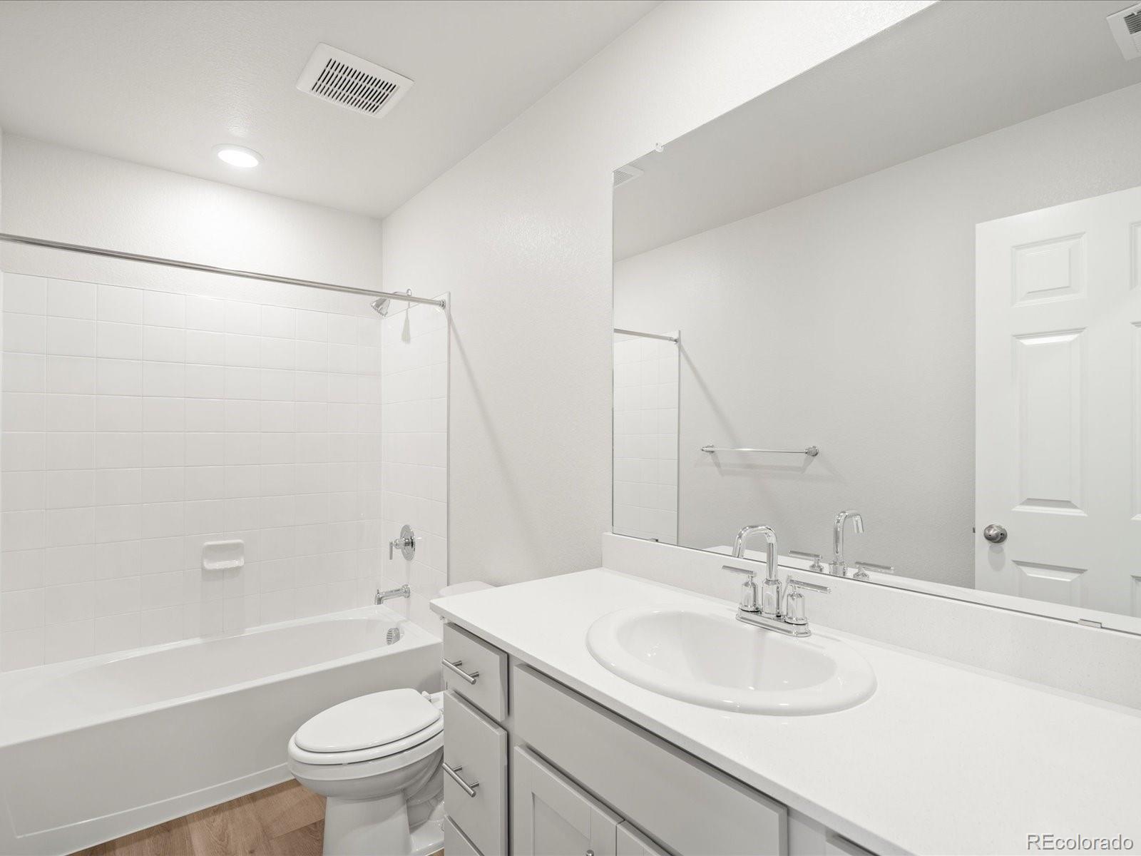 14472 Pansy Loop Morrison, CO 80465 - Photo 19 of 37 a bathroom with a sink toilet vanity and shower