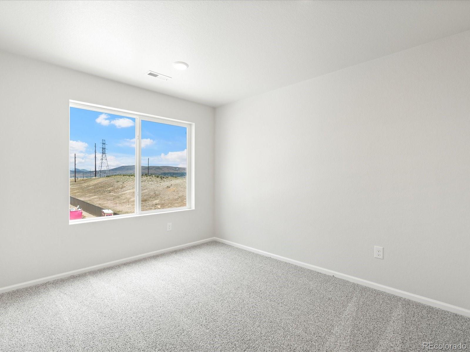 14472 Pansy Loop Morrison, CO 80465 - Photo 20 of 37 an empty room with a window