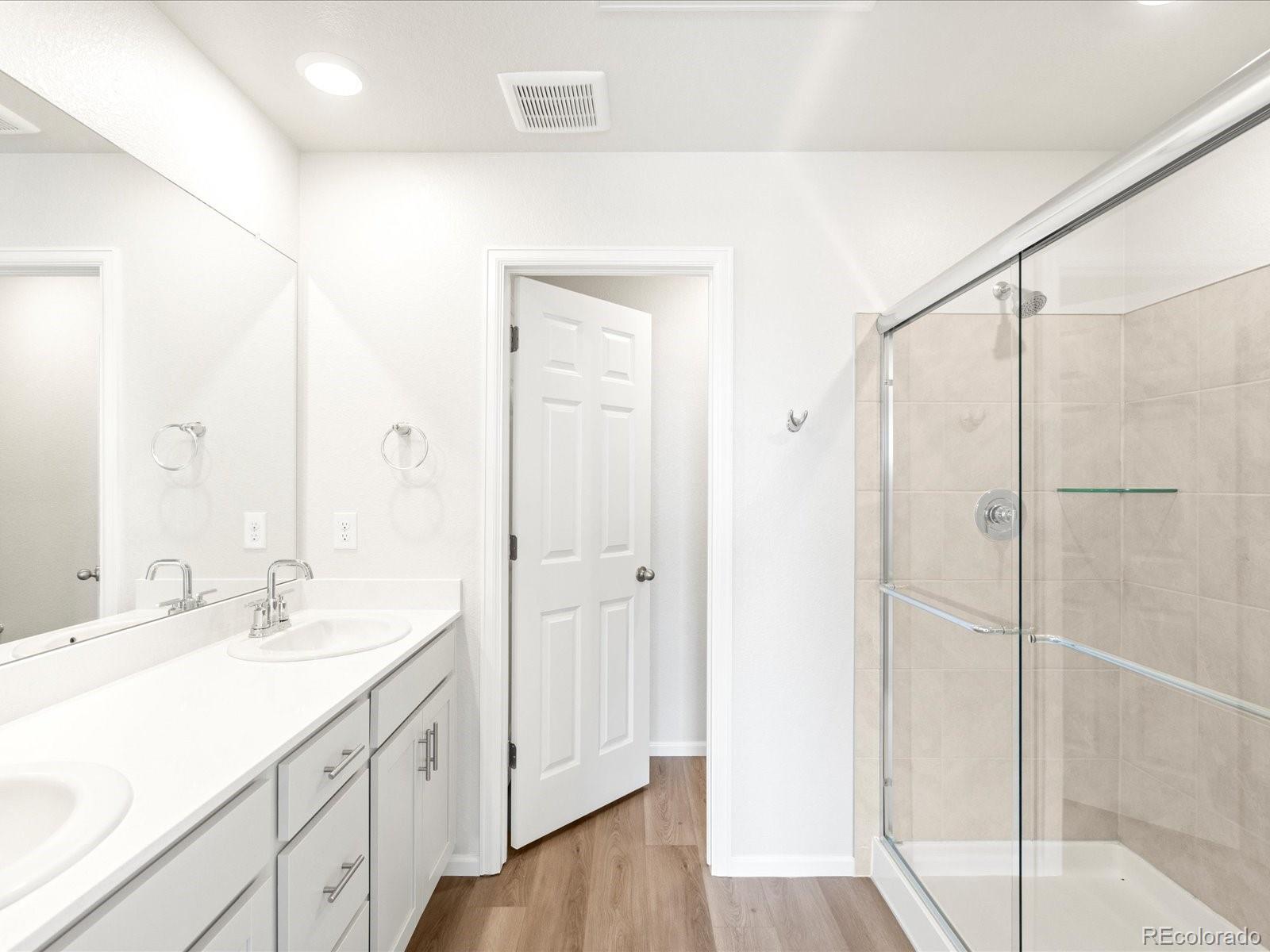 14472 Pansy Loop Morrison, CO 80465 - Photo 29 of 37 a spacious bathroom with a shower sink and mirror