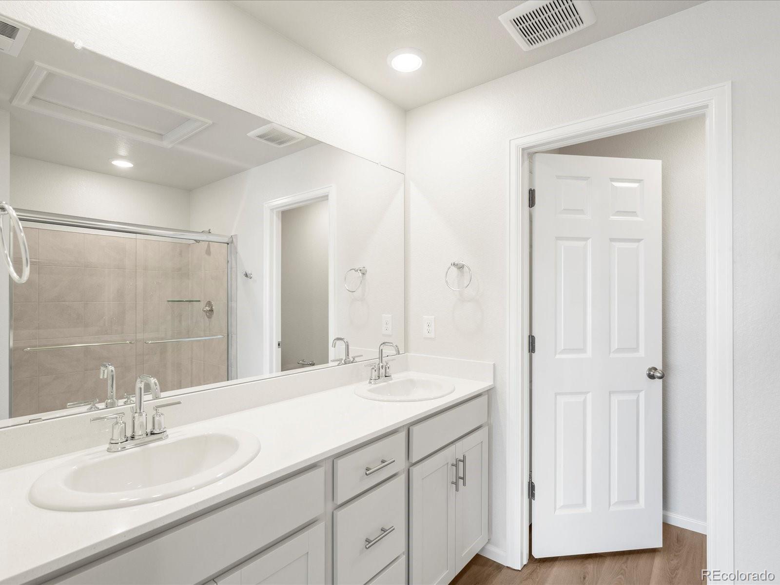 14472 Pansy Loop Morrison, CO 80465 - Photo 30 of 37 a bathroom with a double vanity sink mirror and