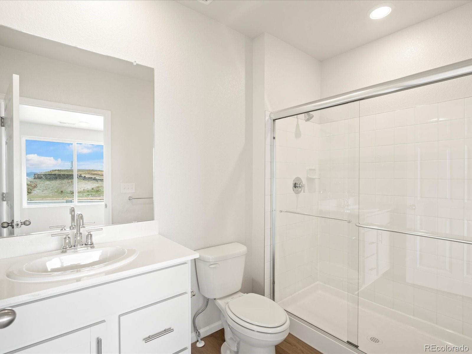 14472 Pansy Loop Morrison, CO 80465 - Photo 5 of 37 a bathroom with a sink toilet and shower