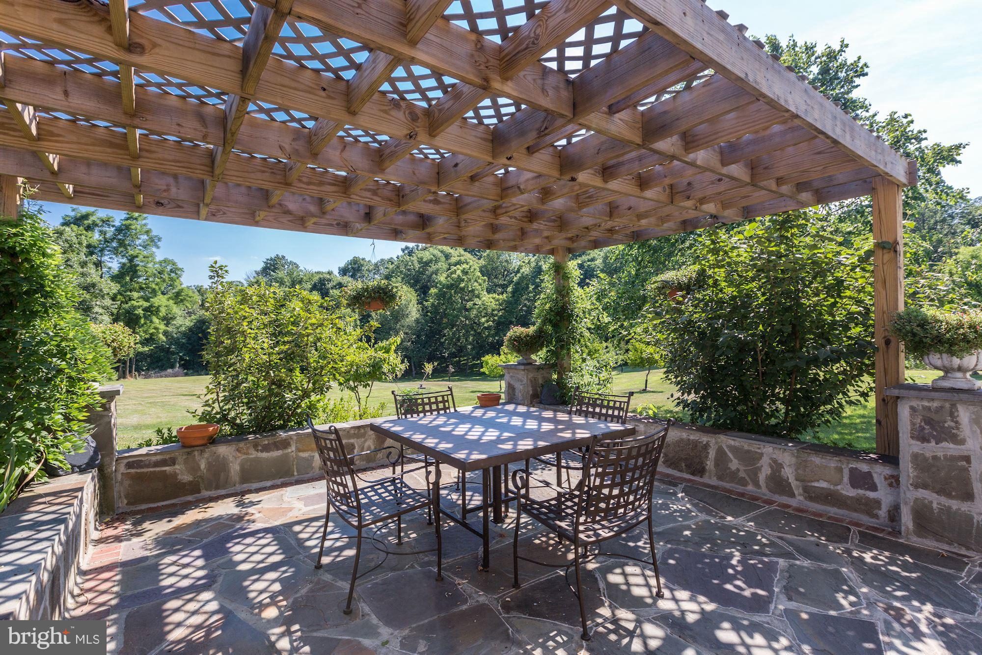 19995 Colchester Road Purcellville, VA 20132 - Photo 27 of 30 Side stone patio w/ covered pergola