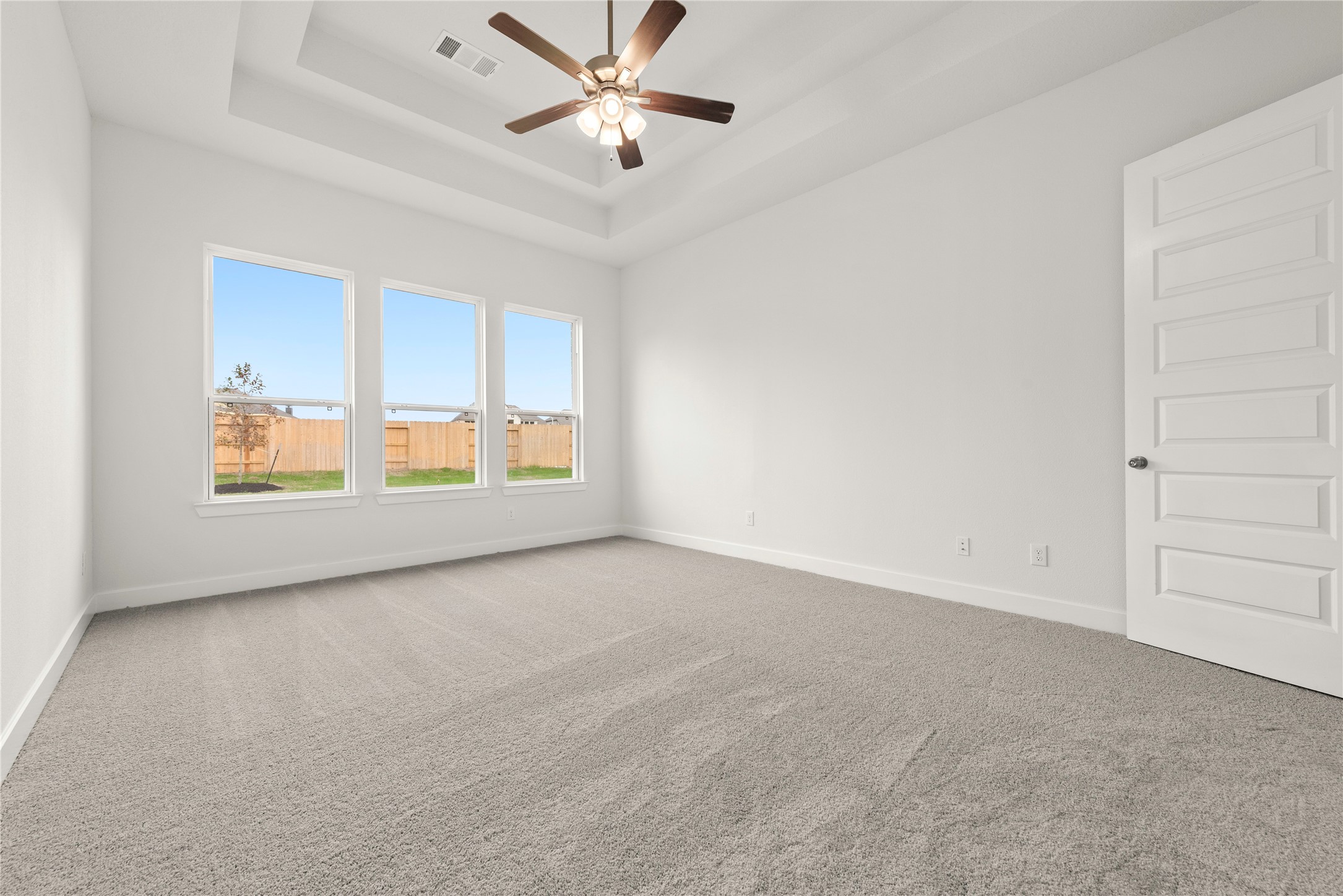 18917 Moonriver Street Conroe, TX 77302 - Photo 8 of 28 an empty room with windows and fan
