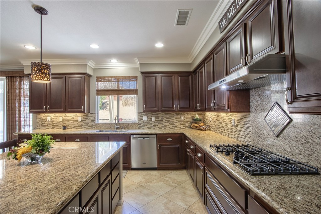 28483 Nautical Point Circle Menifee, CA 92585 - Photo 4 of 44 a large kitchen with stainless steel appliances granite countertop a sink stove and refrigerator
