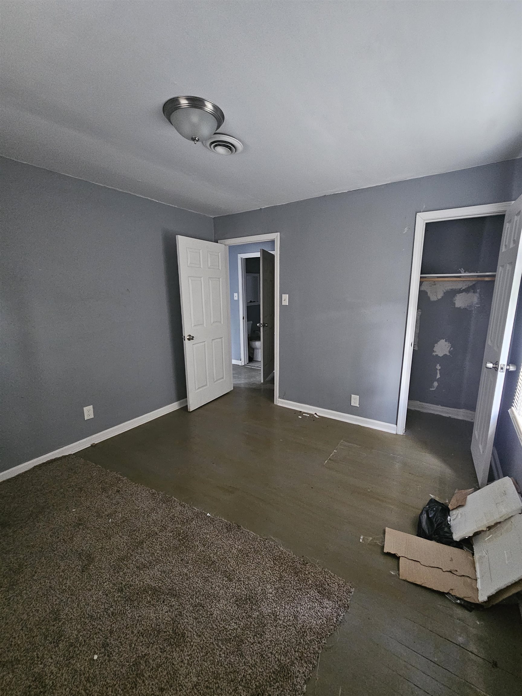 2059 Swift Street Memphis, TN 38109 - Photo 9 of 12 Room featuring painted flooring, grey wall finishes, and a flush mount ceiling light fixture