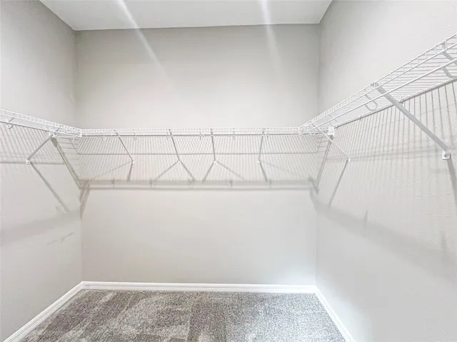 a spacious bathroom with a granite countertop sink and a mirror