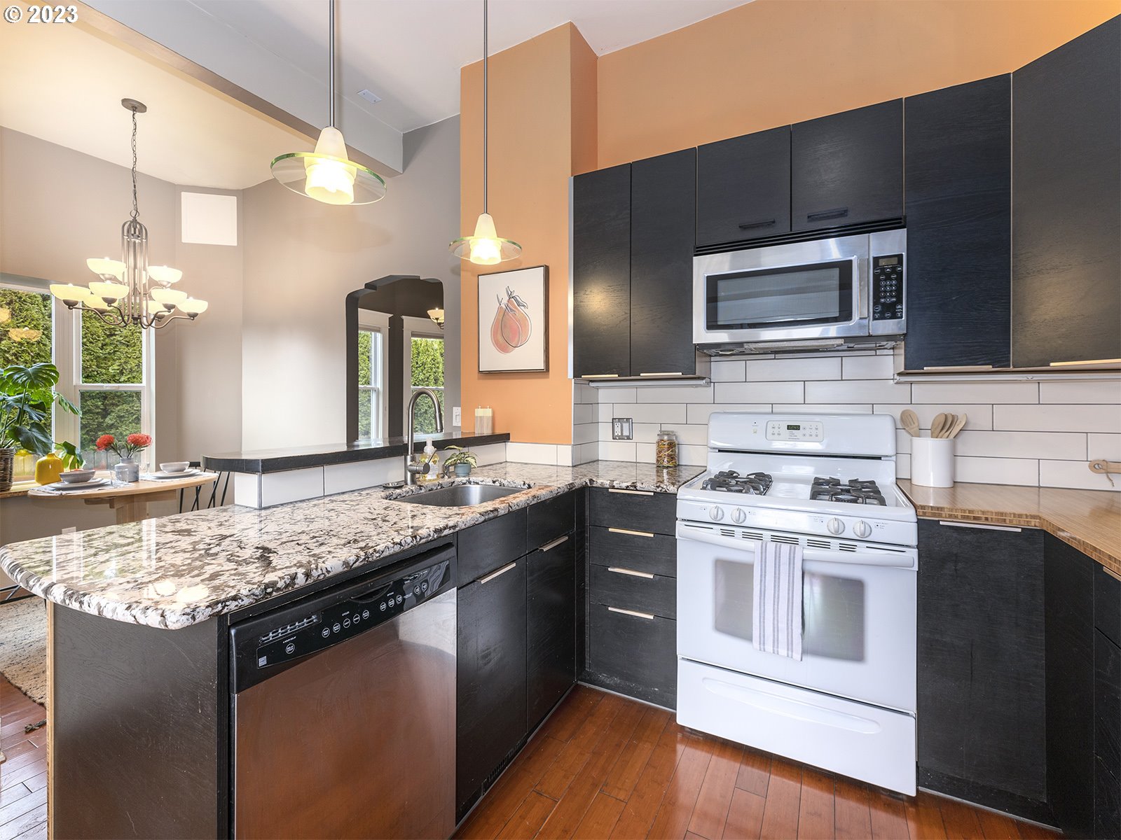314 Northeast 69th Avenue Portland, OR 97213 - Photo 15 of 37 a kitchen with stainless steel appliances granite countertop a stove a sink and a microwave