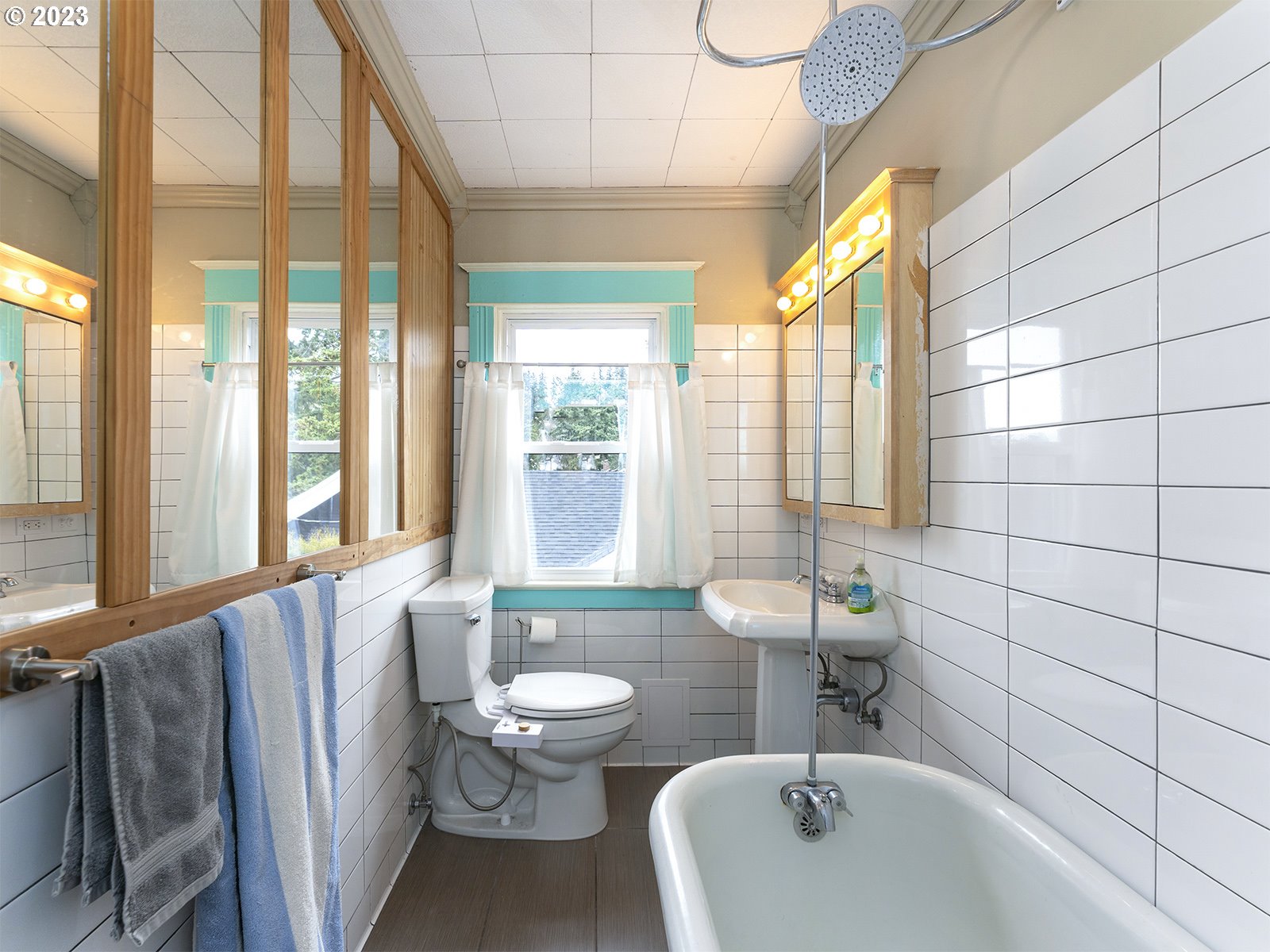 314 Northeast 69th Avenue Portland, OR 97213 - Photo 26 of 37 a bathroom with a sink and mirror with toilet