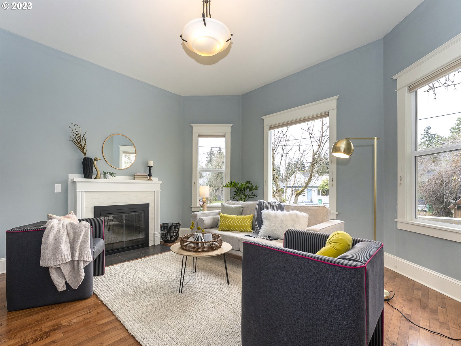 314 Northeast 69th Avenue Portland, OR 97213 - Photo 6 of 37 a living room with furniture a fireplace and a large window