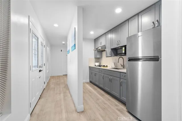 a kitchen with stainless steel appliances a sink stove and cabinets