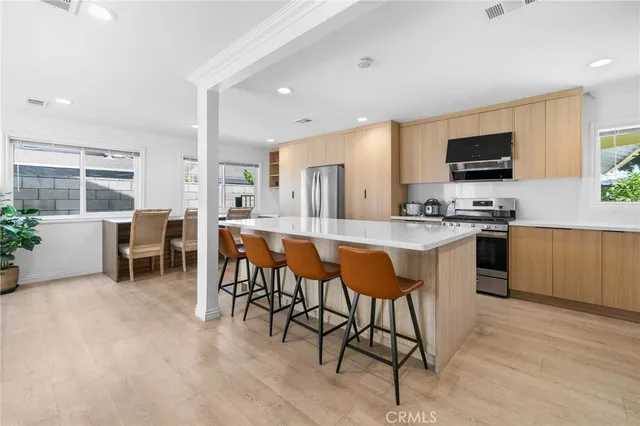 a large white kitchen with a table and chairs
