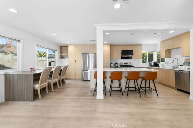 a kitchen with appliances a sink and a refrigerator