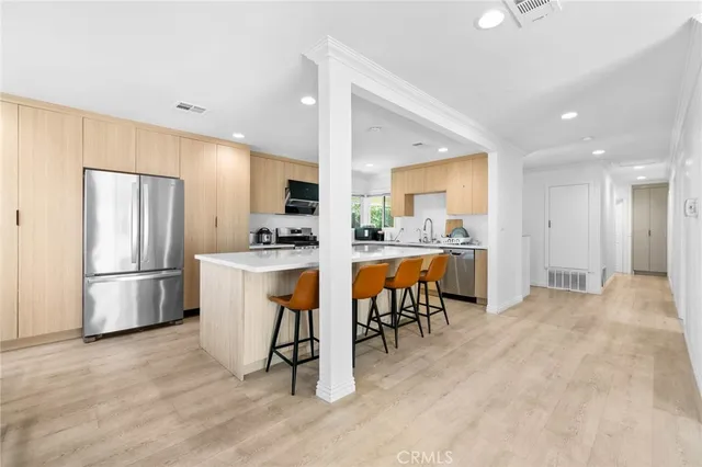 a living room with furniture and kitchen view