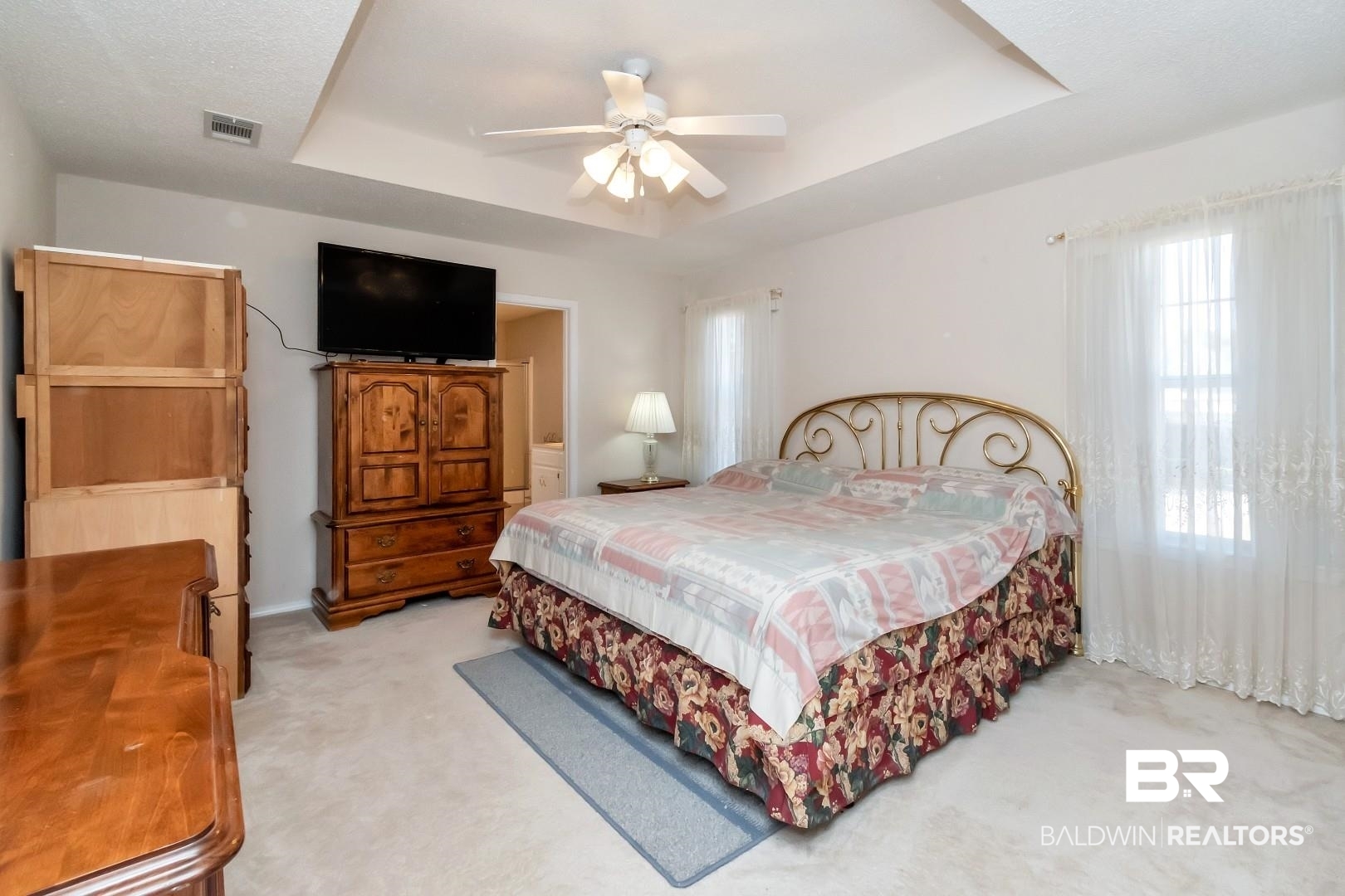 8221 Woodbend Drive Semmes, AL 36575 - Photo 18 of 35 Bedroom with a raised ceiling, light colored carpet, and ceiling fan