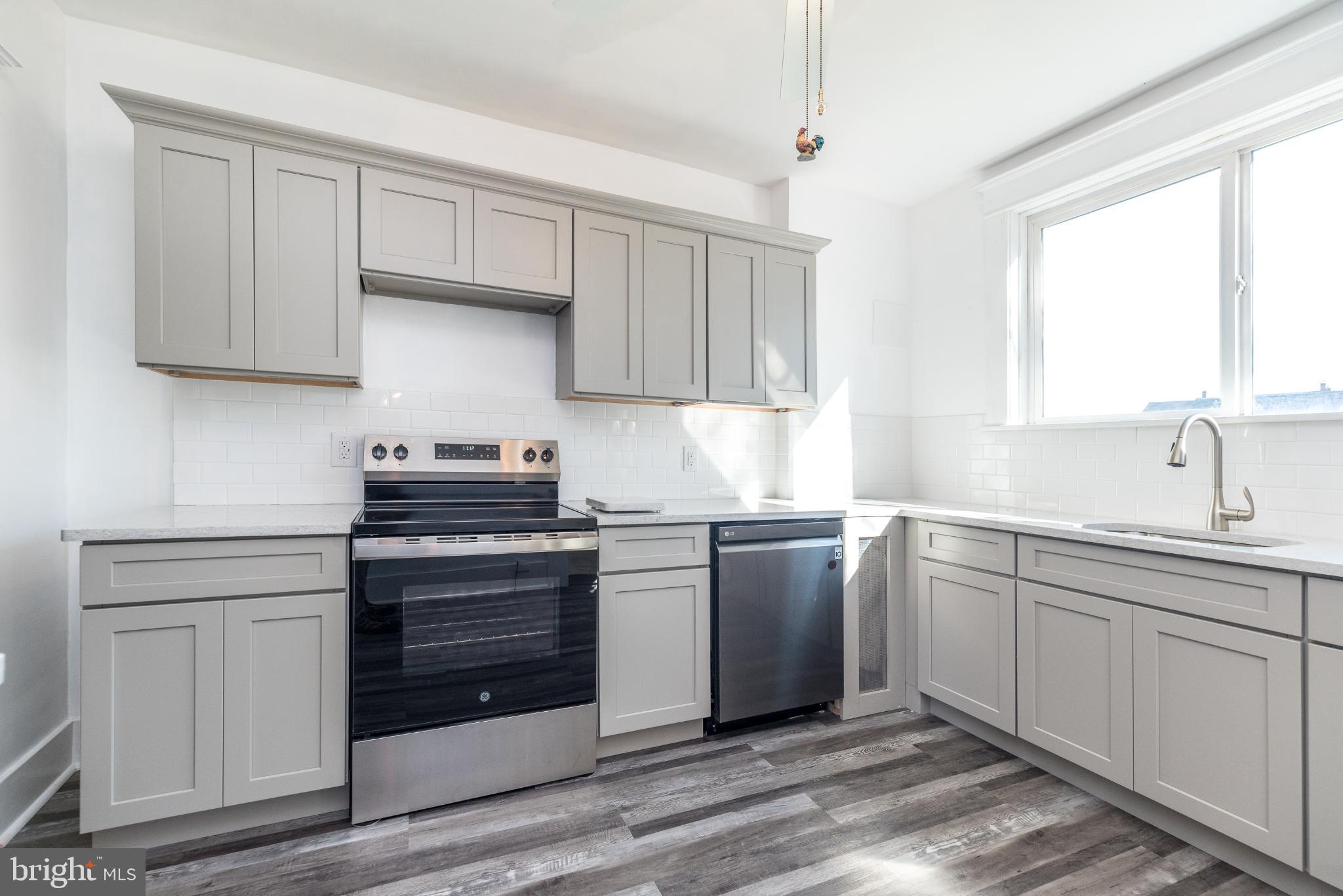 27 South 7th Street Quakertown, PA 18951 - Photo 11 of 33 a kitchen with stainless steel appliances granite countertop a sink and a stove