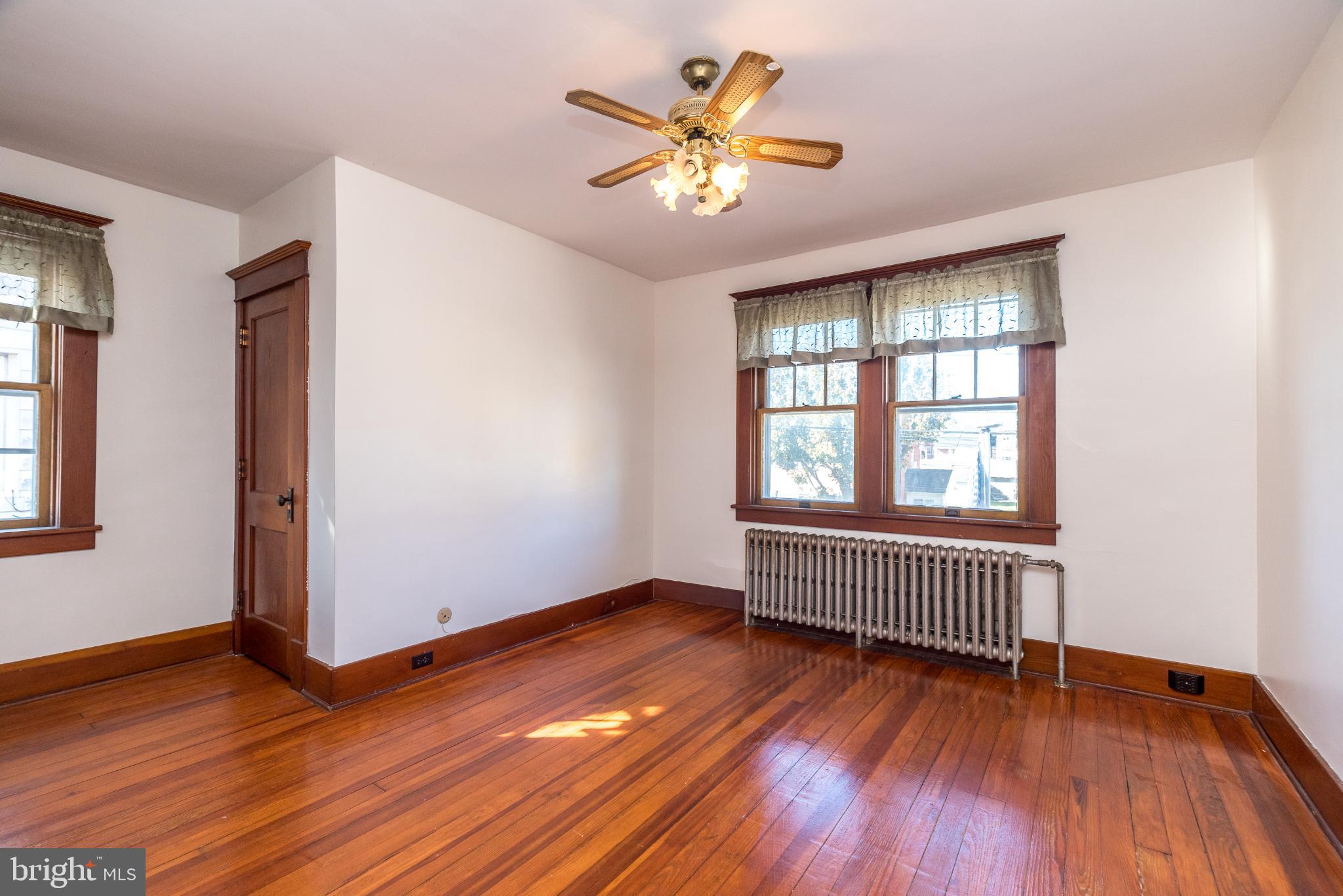 27 South 7th Street Quakertown, PA 18951 - Photo 16 of 33 an empty room with wooden floor and windows