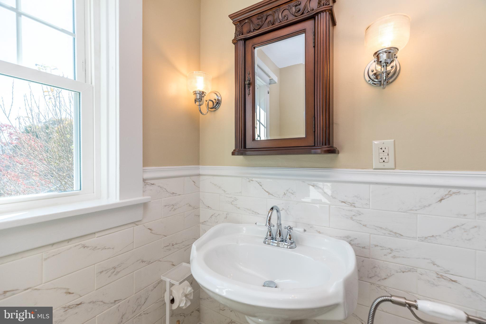 27 South 7th Street Quakertown, PA 18951 - Photo 18 of 33 a bathroom with a sink a mirror and a window