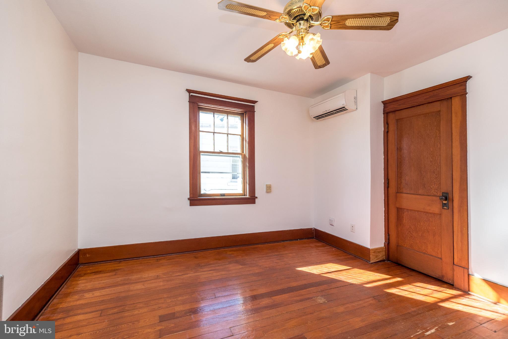 27 South 7th Street Quakertown, PA 18951 - Photo 19 of 33 an empty room with wooden floor closet and windows