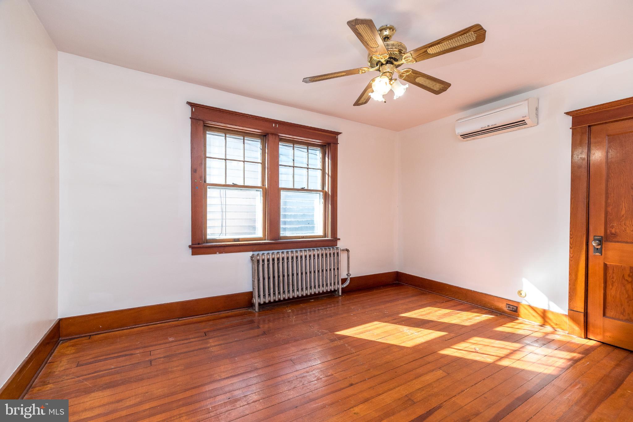 27 South 7th Street Quakertown, PA 18951 - Photo 20 of 33 an empty room with wooden floor and windows