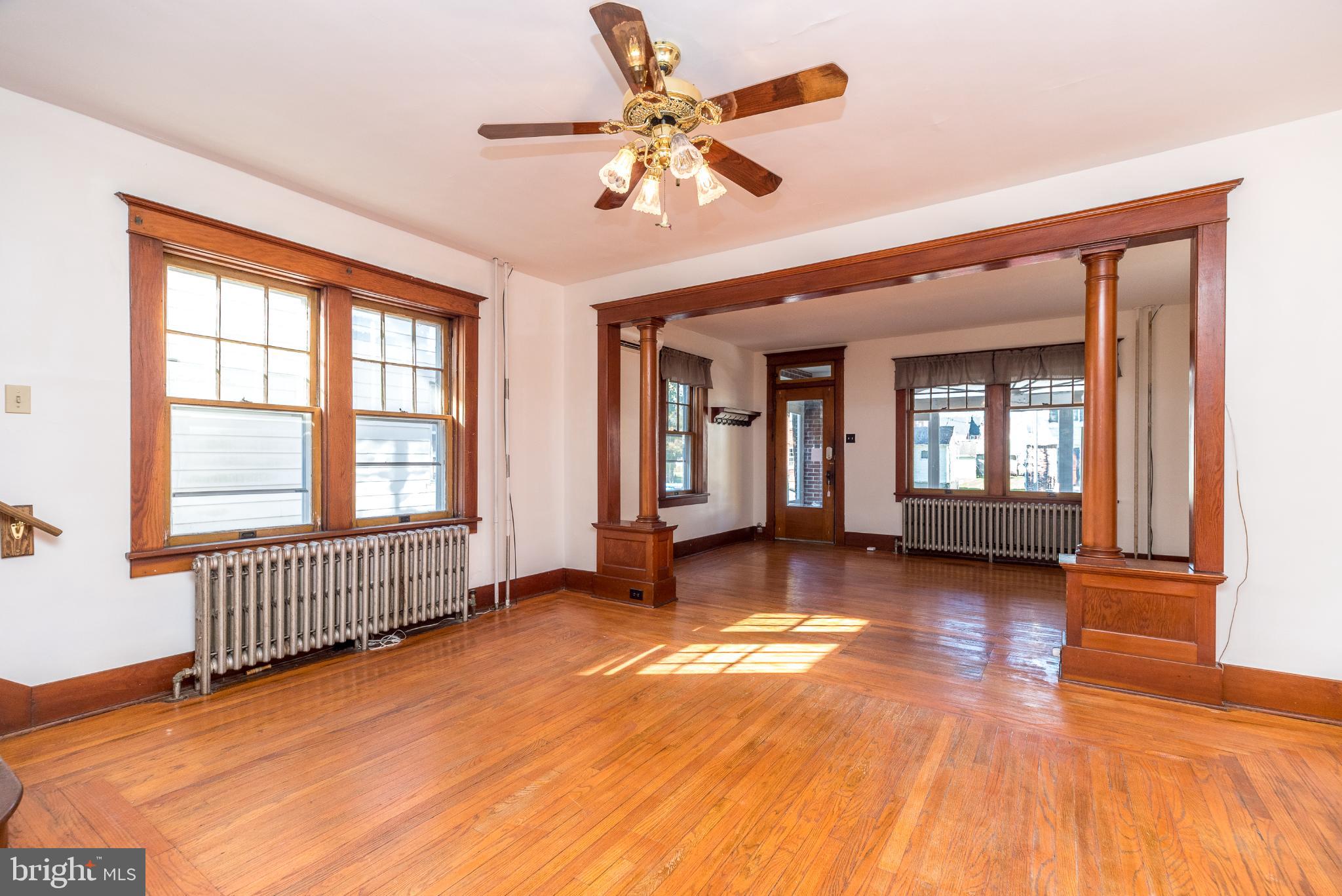 27 South 7th Street Quakertown, PA 18951 - Photo 5 of 33 an empty room with wooden floor and windows