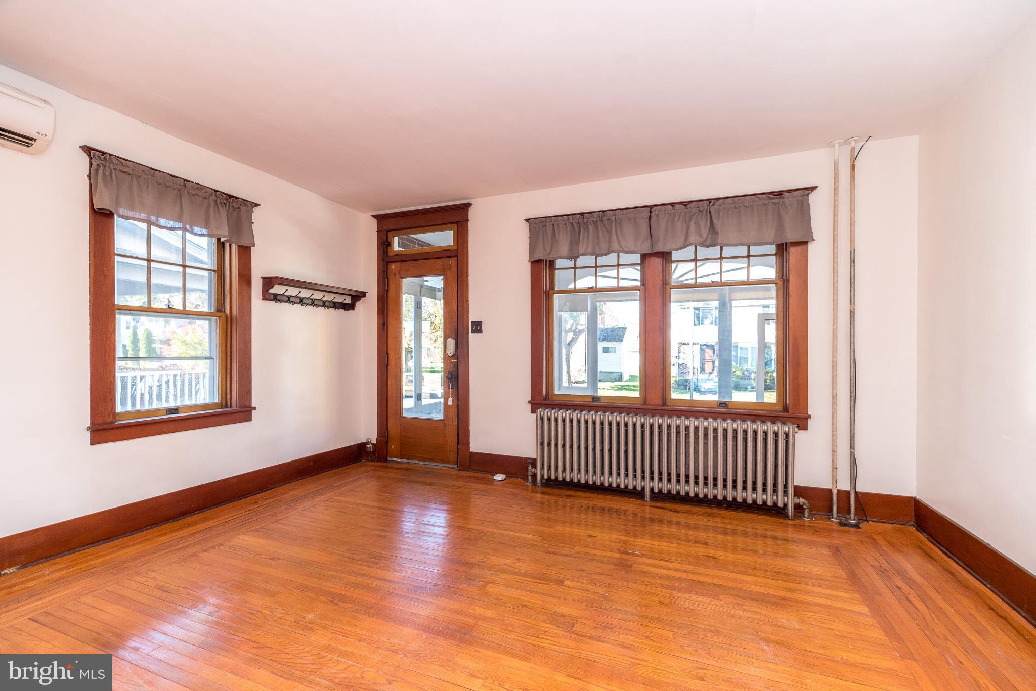 27 South 7th Street Quakertown, PA 18951 - Photo 6 of 33 an empty room with wooden floor and windows