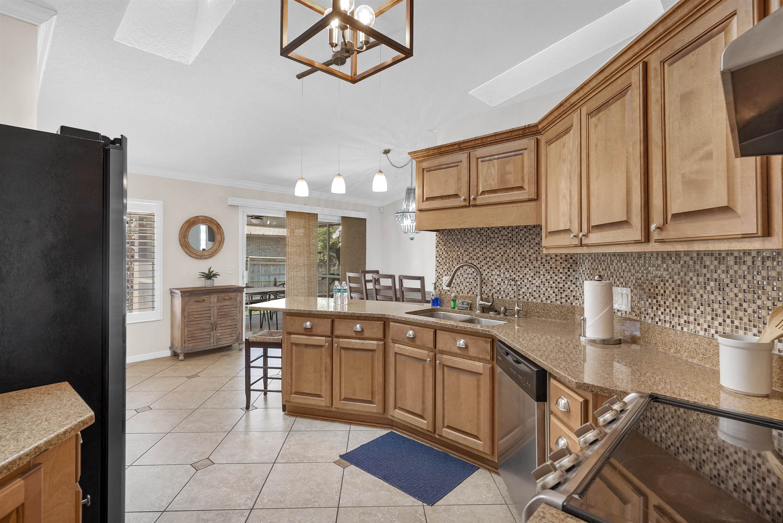 404 Fourteenth Street St. Augustine, FL 32084 - Photo 12 of 35 a kitchen with stainless steel appliances granite countertop a sink and cabinets