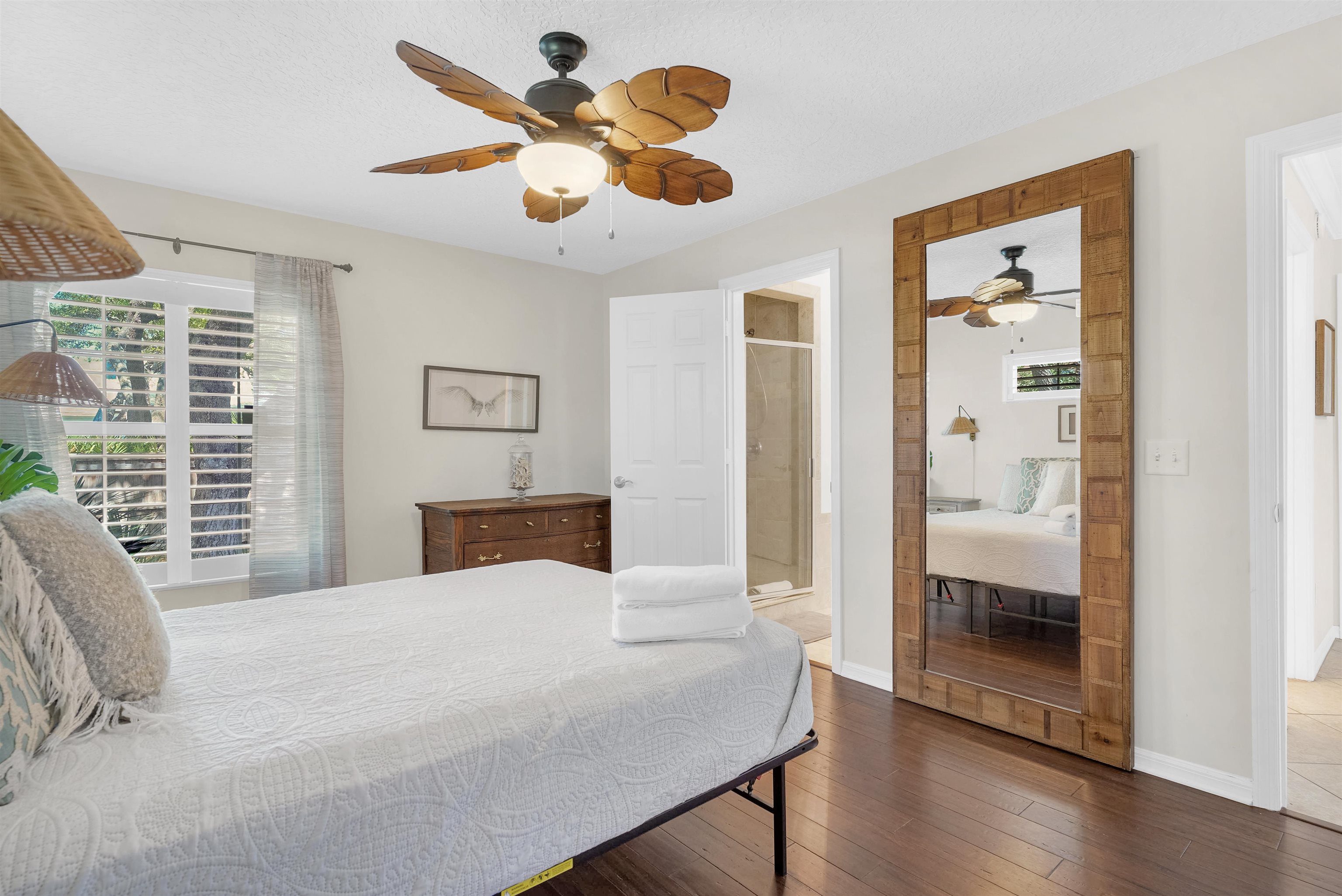404 Fourteenth Street St. Augustine, FL 32084 - Photo 16 of 35 a bedroom with a large bed and a chandelier
