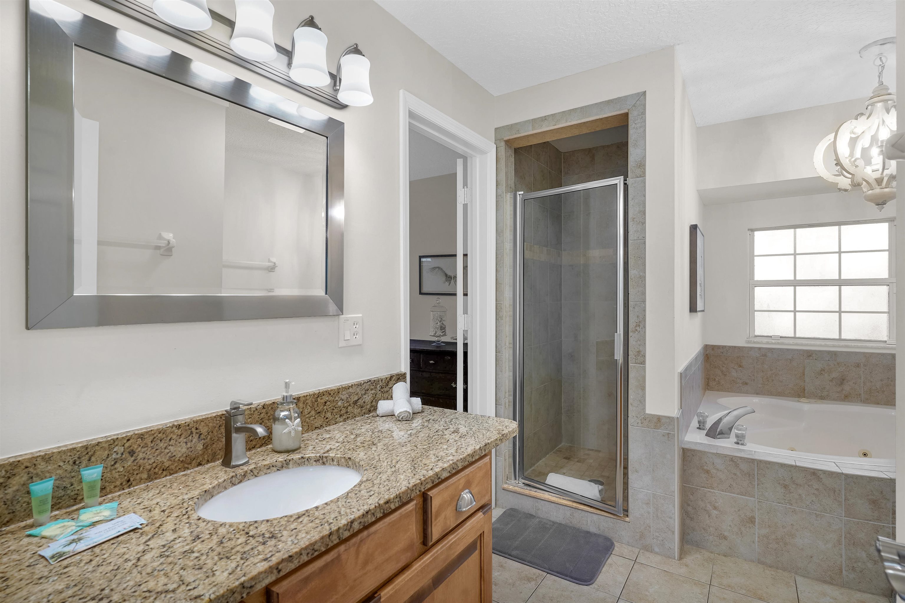 404 Fourteenth Street St. Augustine, FL 32084 - Photo 18 of 35 a bathroom with a granite countertop tub sink and mirror