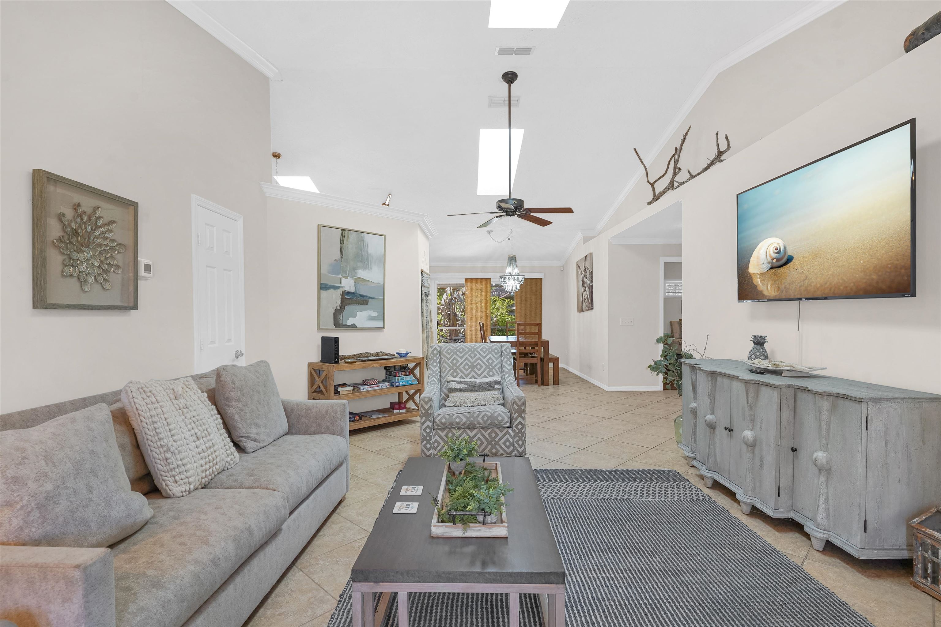 404 Fourteenth Street St. Augustine, FL 32084 - Photo 2 of 35 a living room with furniture a flat screen tv and a large window