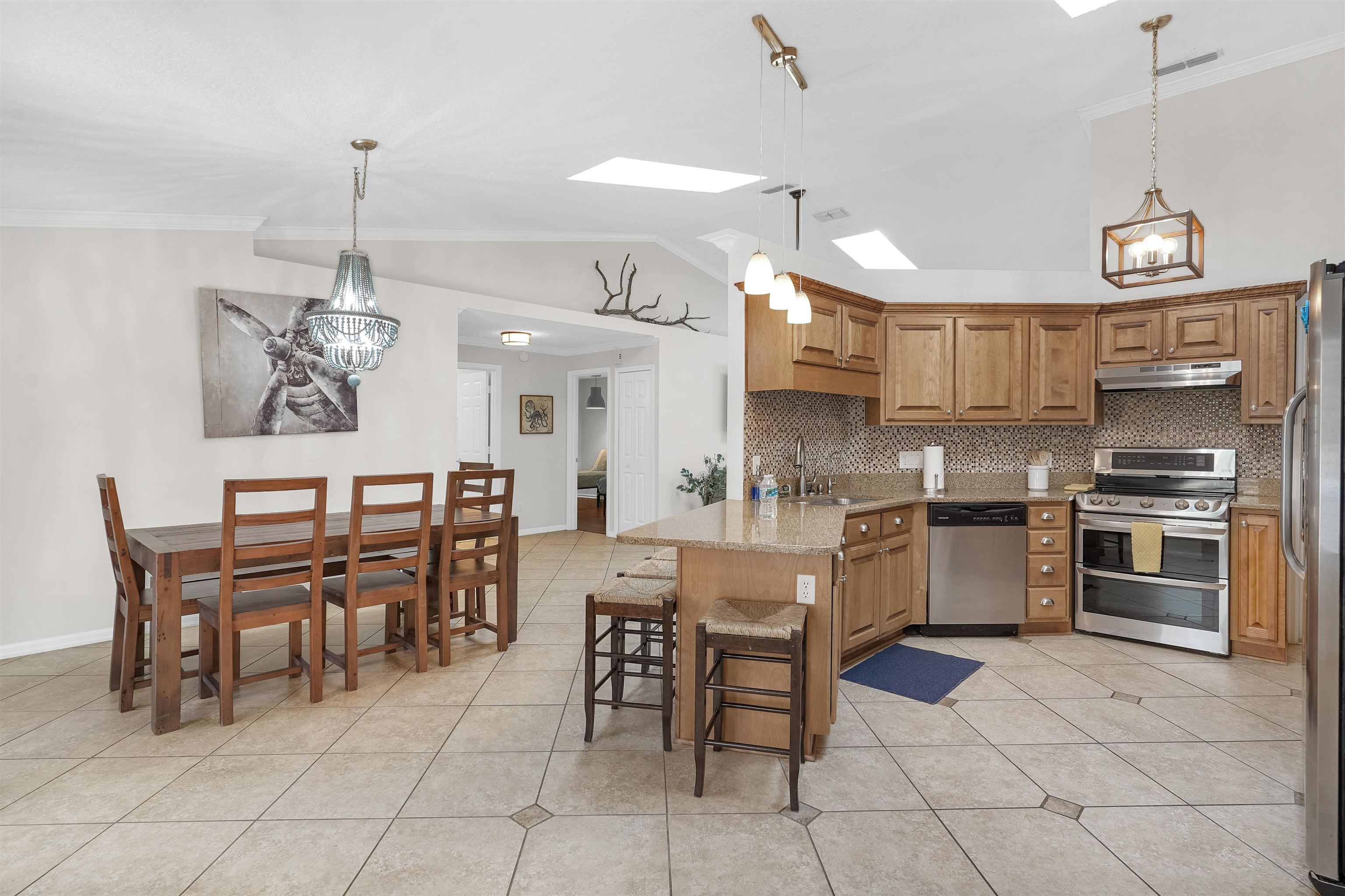 404 Fourteenth Street St. Augustine, FL 32084 - Photo 10 of 35 a kitchen with stainless steel appliances granite countertop a sink a stove a dining table and chairs