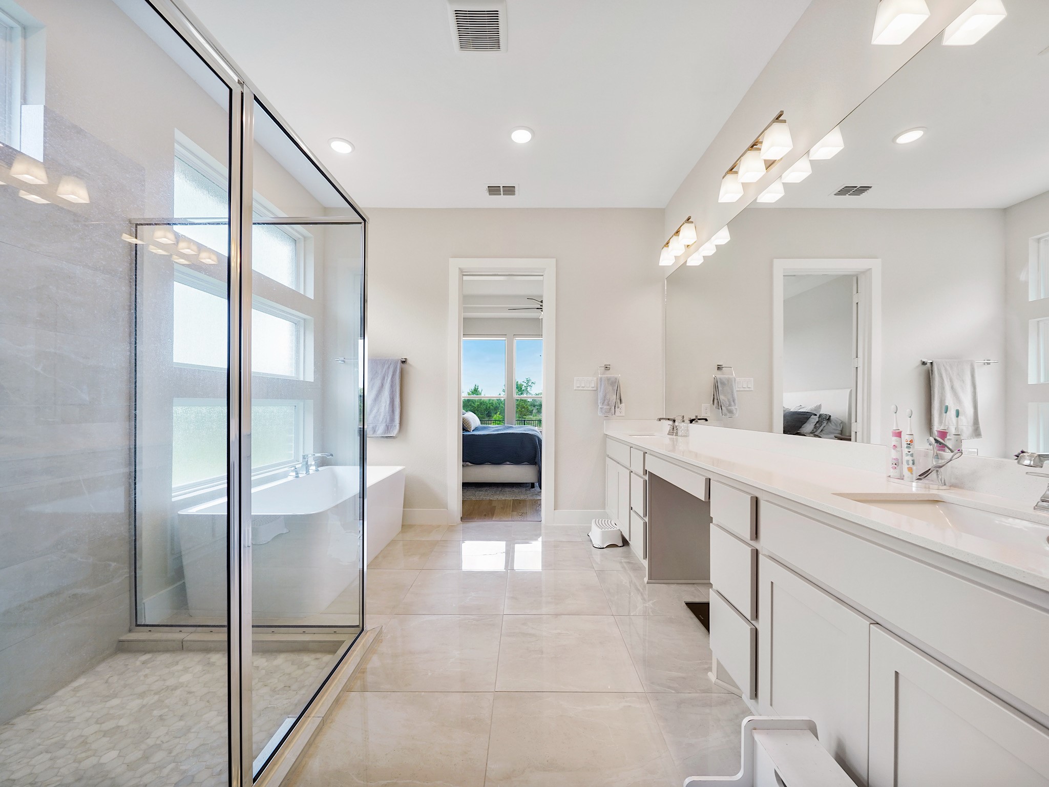 5802 Emerald Ranch Lane Fulshear, TX 77441 - Photo 24 of 45 The spa-like primary ensuite features dual sinks with an extensive vanity, upgraded finishes, an oversized walk-in shower, and a freestanding soaking tub designed for relaxation and everyday luxury.