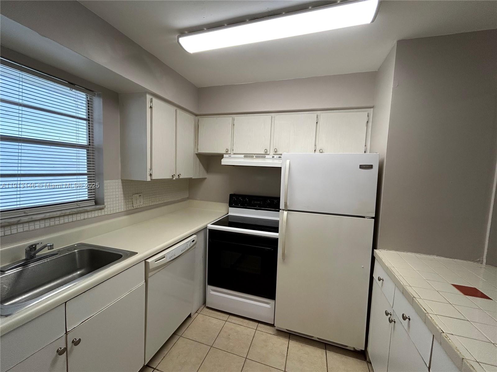 6505 Winfield Boulevard, Unit B18 Margate, FL 33063 - Photo 1 of 15 a kitchen with a refrigerator sink and stove