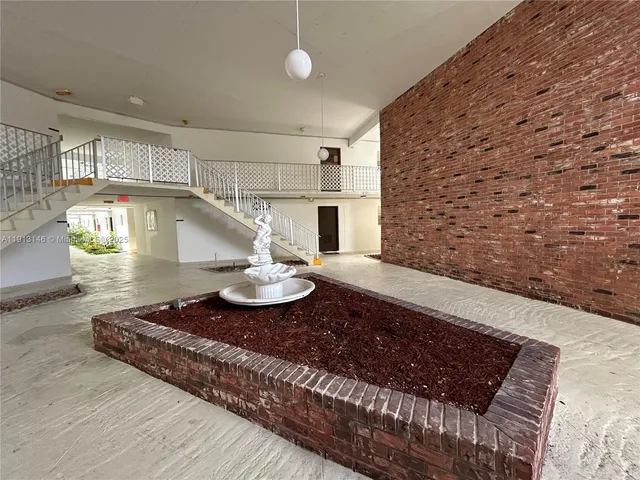 a view of kitchen with granite countertop stove top oven and cabinets