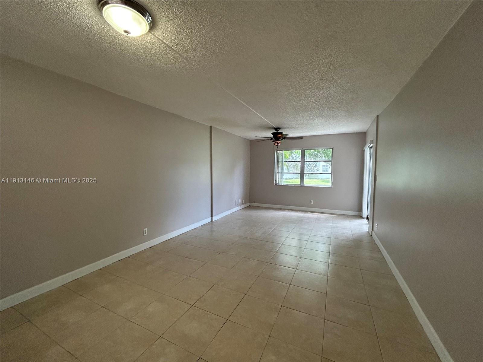 6505 Winfield Boulevard, Unit B18 Margate, FL 33063 - Photo 2 of 15 an empty room with windows