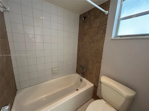 a bathroom with a toilet and bathtub