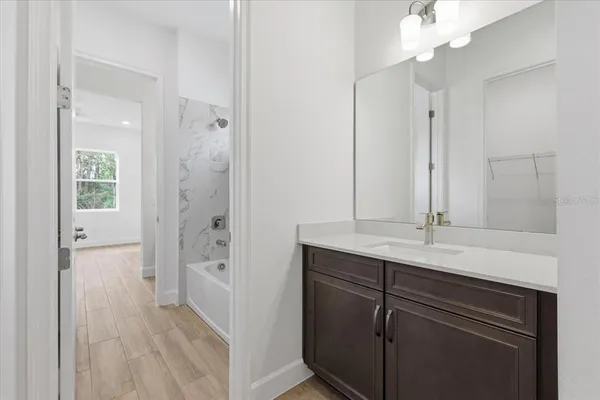 a bathroom with a sink a shower and a mirror