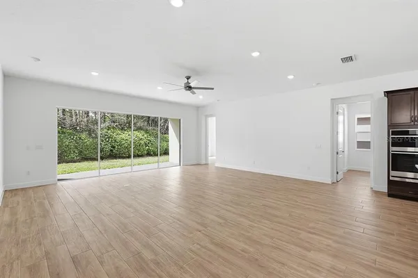 a view of empty room with wooden floor and fireplace