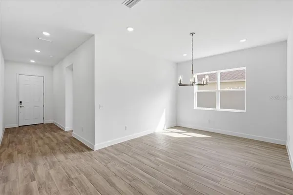 a view of a room with wooden floor and window