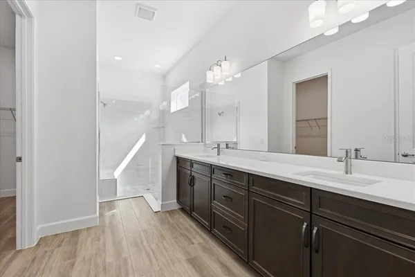 a bathroom with a double vanity sink and mirror