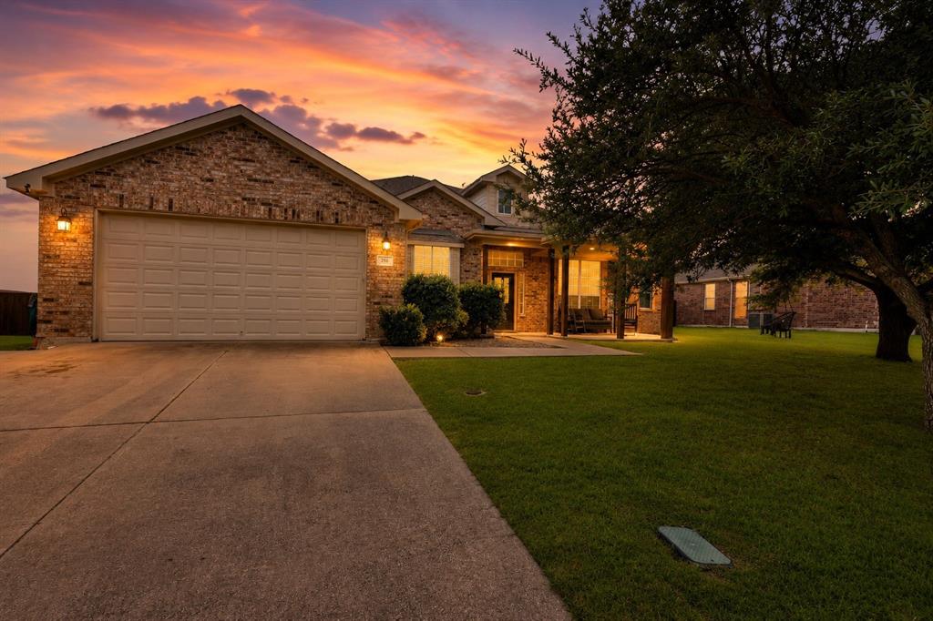 205 King George Road Ponder, TX 76259 - Photo 1 of 37 Brick veneer exterior with an attached garage, concrete driveway, covered front porch, and established lawn