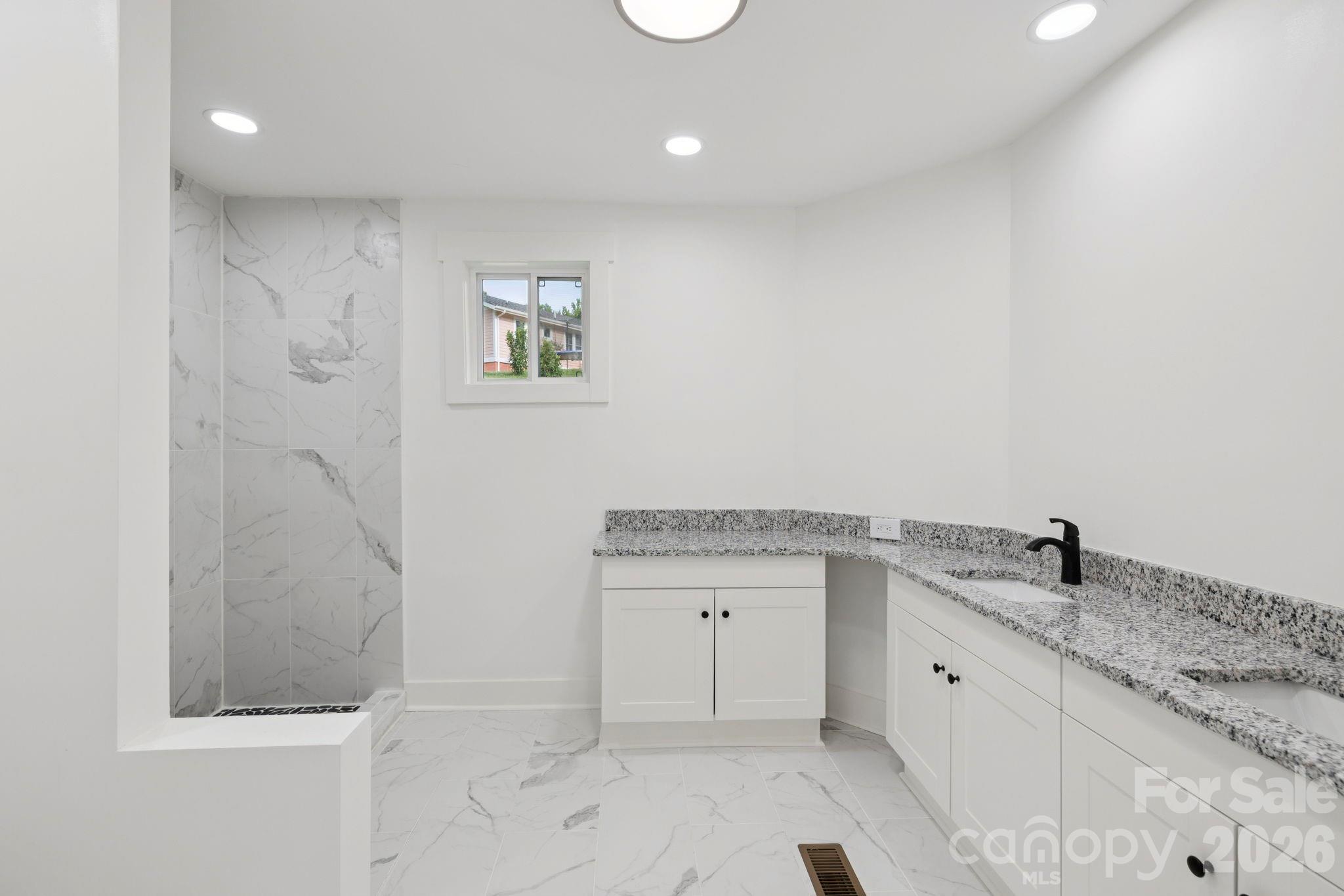 431 Pole Miller Extension Brevard, NC 28712 - Photo 4 of 24 a spacious bathroom with a granite countertop sink a mirror and a shower
