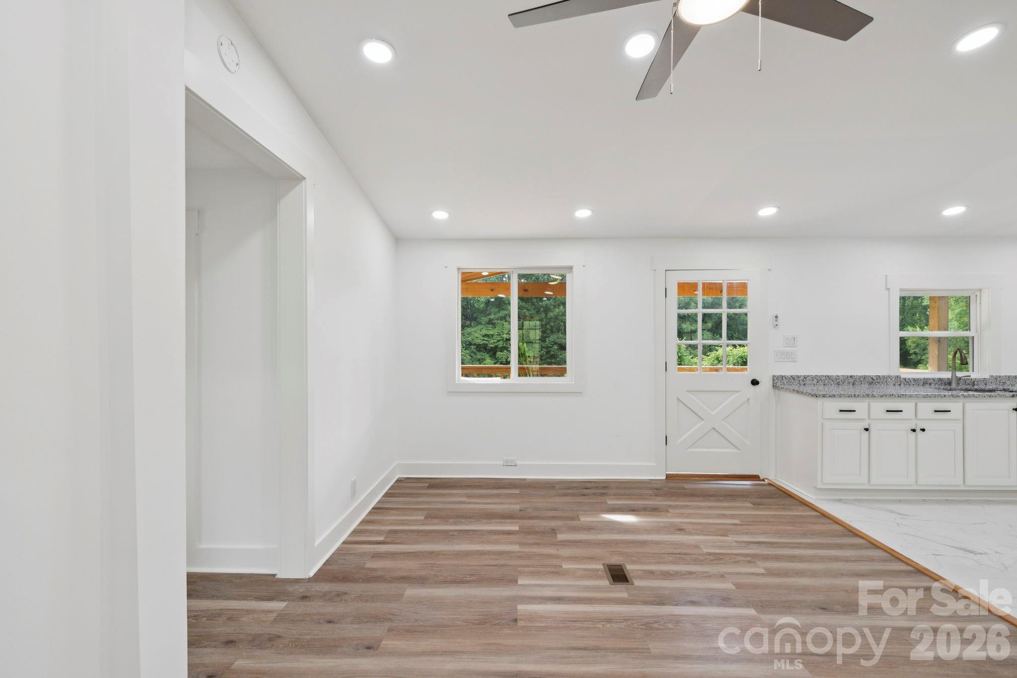 431 Pole Miller Extension Brevard, NC 28712 - Photo 7 of 24 a view of a kitchen with wooden floor and window